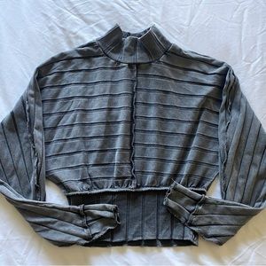 grey/blue turtleneck, ridged.